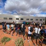 Cast and crew of the 'Amazing Race Australia', series 5 outside the Ghan near Coober Pedy.